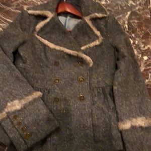 100 wool, rabbit fur trim on edges and cuffs. Beautiful fabric peplum